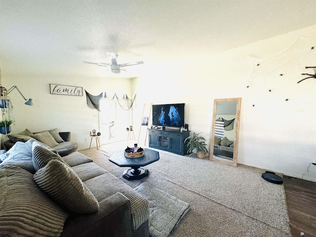 living room featuring ceiling fan and a textured ceiling