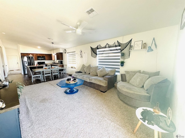 living room featuring dark wood-type flooring, ceiling fan, and lofted ceiling