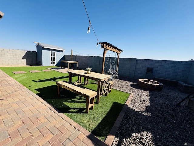 view of yard with a fire pit and a storage unit