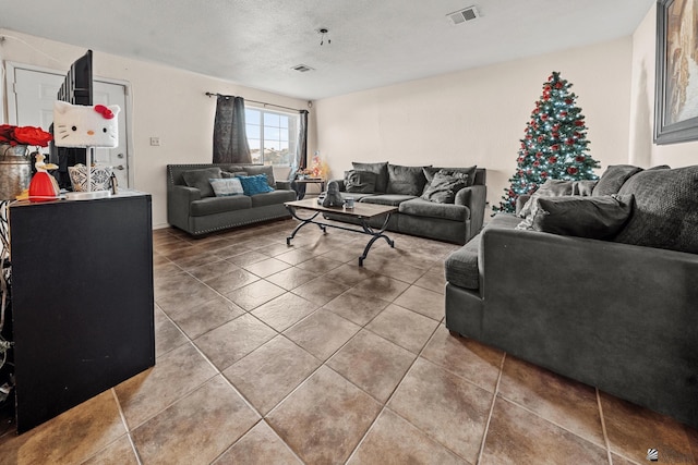 living area with tile patterned flooring and visible vents