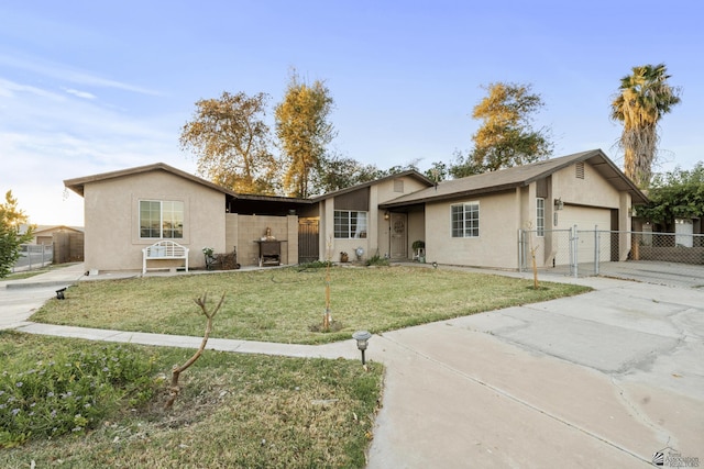 ranch-style home featuring driveway, an attached garage, fence, a front lawn, and stucco siding