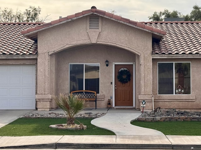 doorway to property with a garage