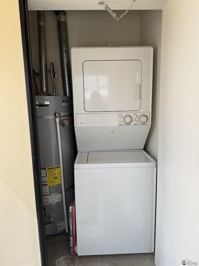 laundry area featuring gas water heater, stacked washer / drying machine, and laundry area