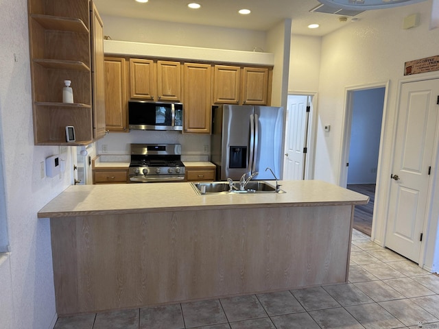 kitchen featuring light tile patterned floors, open shelves, stainless steel appliances, and a sink