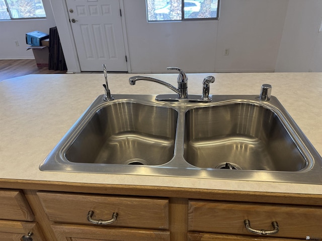 interior details featuring brown cabinets, light countertops, and a sink