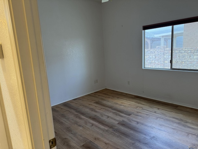 spare room featuring wood finished floors