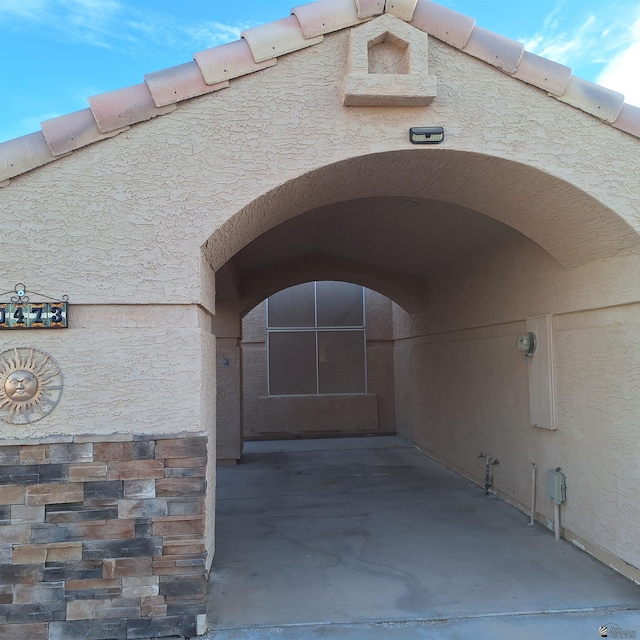 property entrance with stucco siding