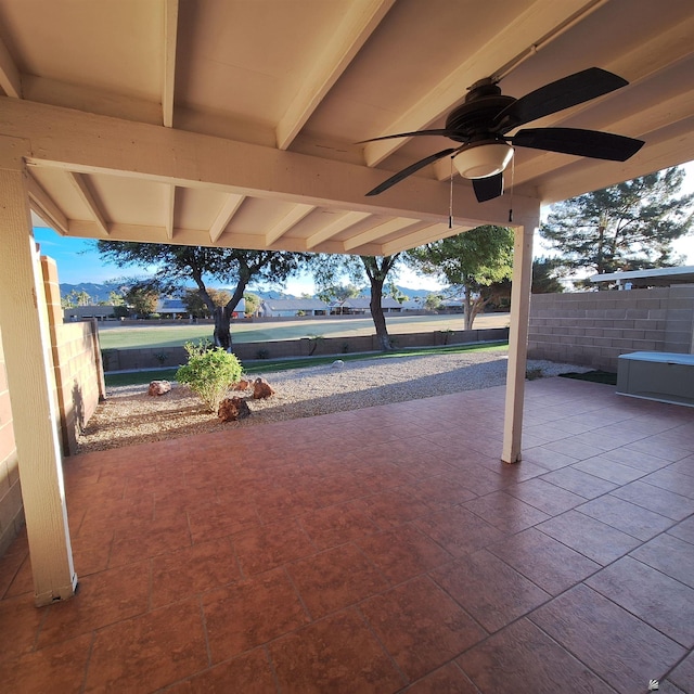 view of patio with fence and a ceiling fan