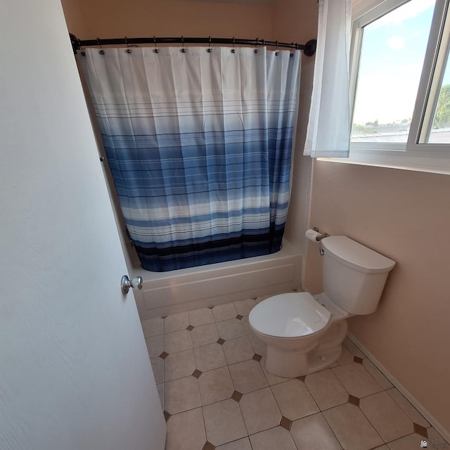 bathroom with shower / tub combo, tile patterned flooring, toilet, and baseboards