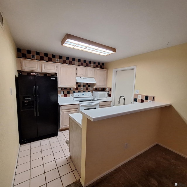 kitchen with light tile patterned floors, white appliances, tasteful backsplash, light countertops, and under cabinet range hood