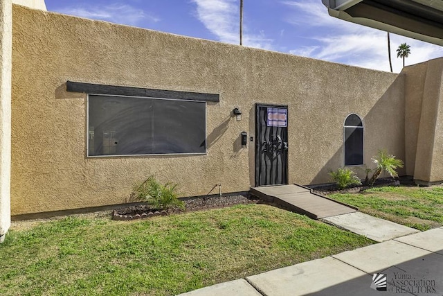 property entrance with a yard