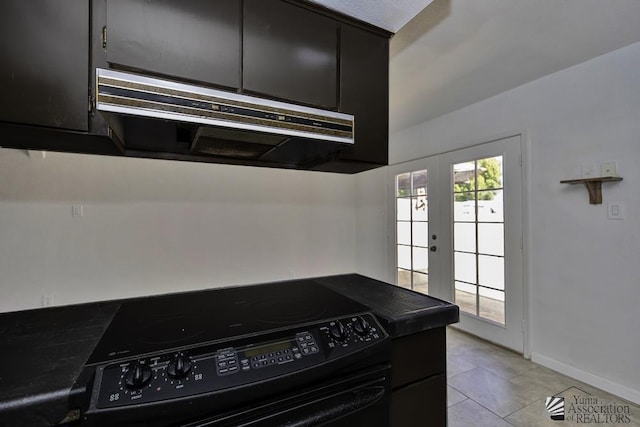 kitchen featuring light tile patterned floors, electric range, and french doors