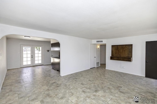 unfurnished living room with french doors