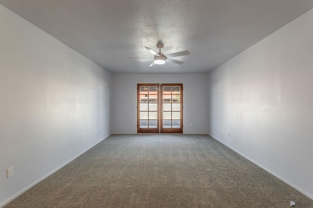 spare room with ceiling fan, a textured ceiling, and carpet flooring