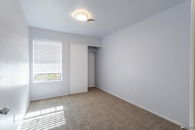 unfurnished bedroom with carpet floors and a closet