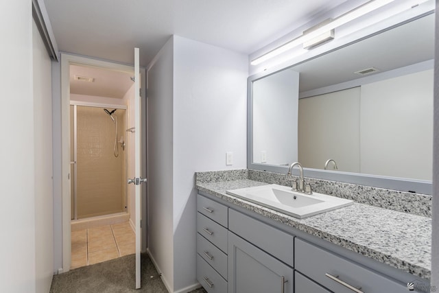 bathroom featuring a shower, tile patterned floors, and vanity