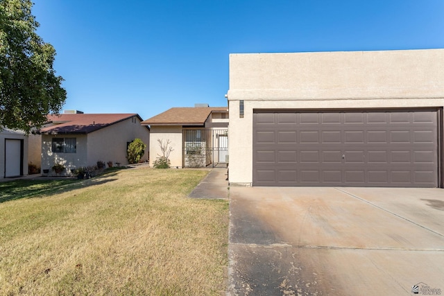 view of front of property with a garage and a front lawn