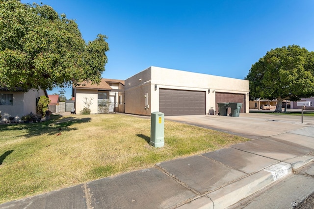 view of front of property with a garage and a front yard