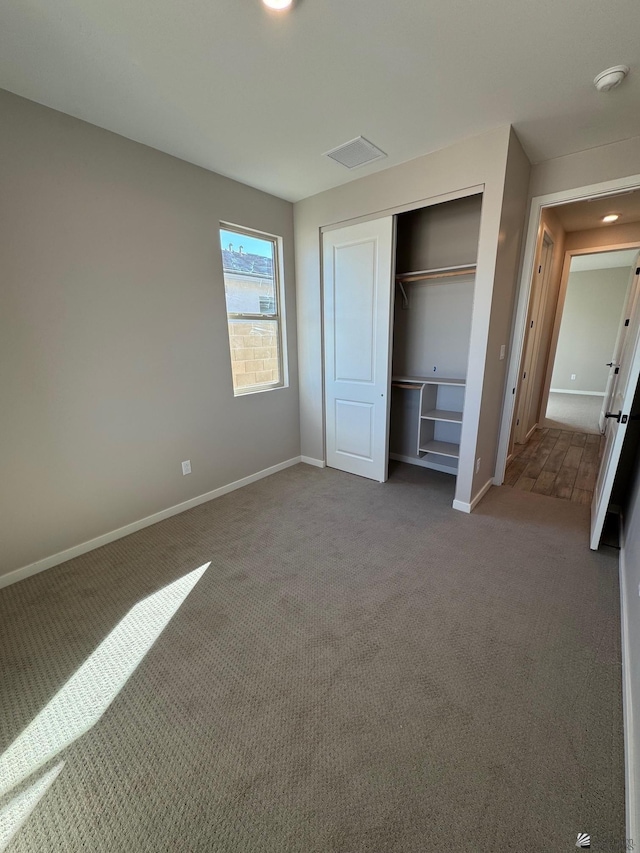 unfurnished bedroom with carpet and a closet