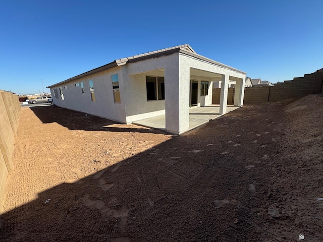 view of side of property featuring a patio area