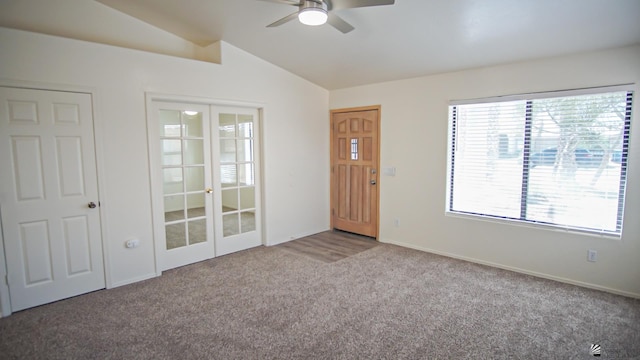 unfurnished room with ceiling fan, french doors, a healthy amount of sunlight, carpet floors, and vaulted ceiling