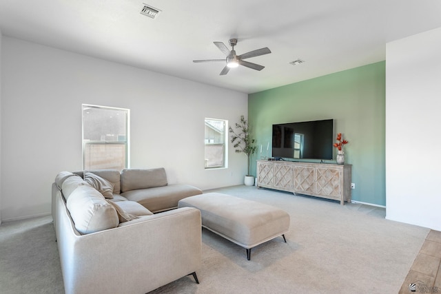 living room featuring ceiling fan and light colored carpet