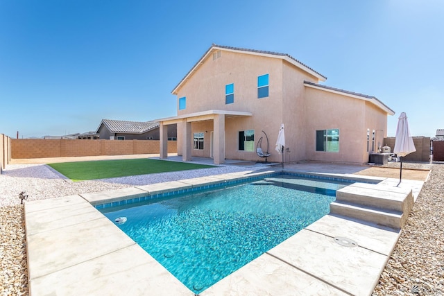 view of swimming pool featuring central AC unit, a patio, and a yard