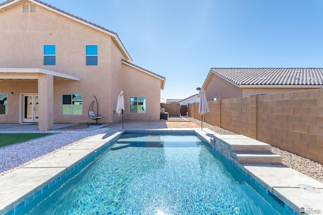 view of pool with a patio area and french doors