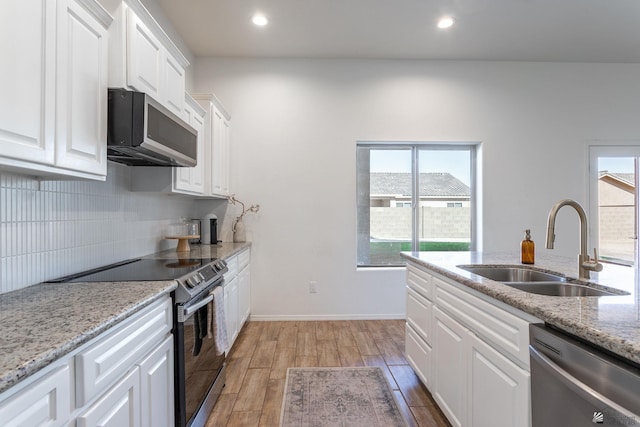 kitchen with sink, white cabinets, and stainless steel appliances