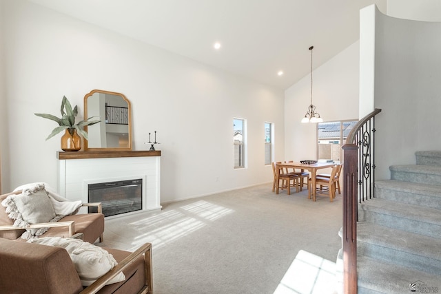 living room with high vaulted ceiling and light carpet