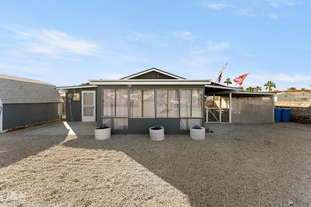 back of house with a sunroom