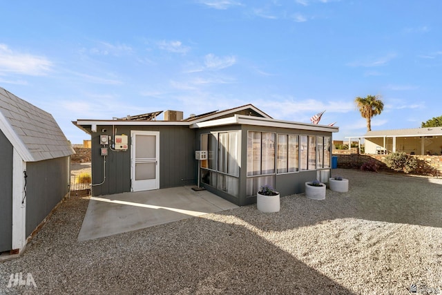 rear view of property featuring a sunroom