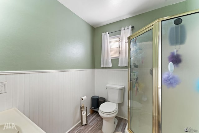 bathroom featuring hardwood / wood-style floors, an enclosed shower, and toilet