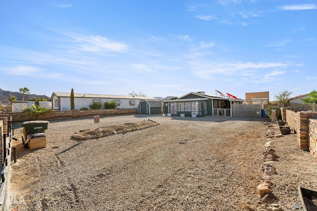 rear view of property featuring an outbuilding