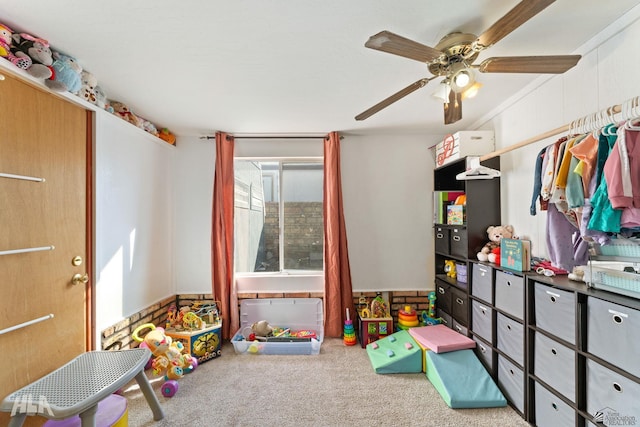 game room with ceiling fan and light colored carpet