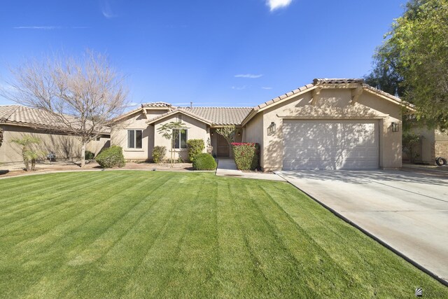 view of front of home with a front yard and a garage