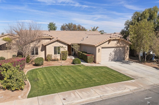 view of front of house featuring an attached garage, stucco siding, a tiled roof, and a front yard