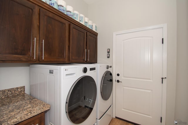 laundry area with cabinets and independent washer and dryer