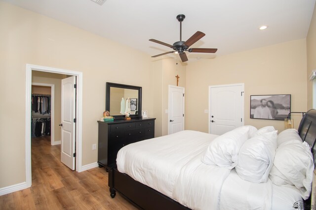 bedroom with light hardwood / wood-style flooring and ceiling fan