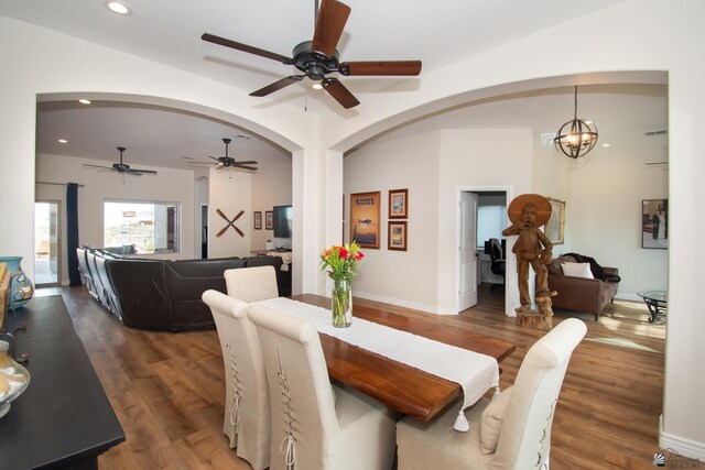 dining area featuring dark wood-type flooring and a chandelier