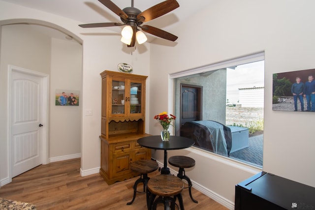 dining space with ceiling fan and light hardwood / wood-style flooring