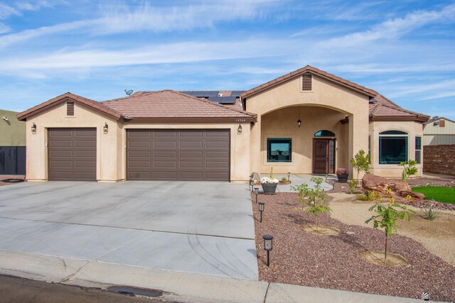 view of front of house featuring a garage and solar panels