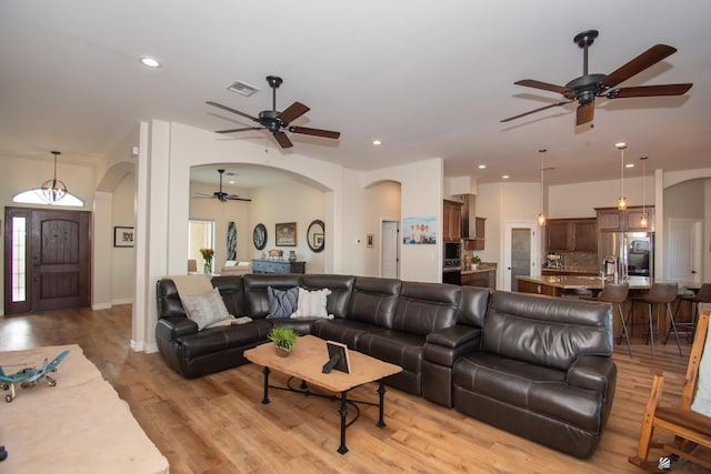 living room featuring ceiling fan and light hardwood / wood-style floors