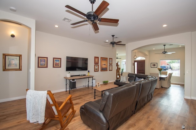 living room featuring ceiling fan and light wood-type flooring