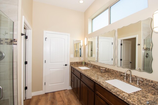 bathroom featuring hardwood / wood-style floors, vanity, and an enclosed shower