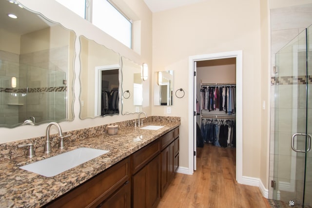 bathroom featuring vanity, wood-type flooring, and an enclosed shower