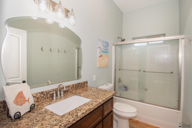 full bathroom featuring shower / bath combination with glass door, vanity, and toilet