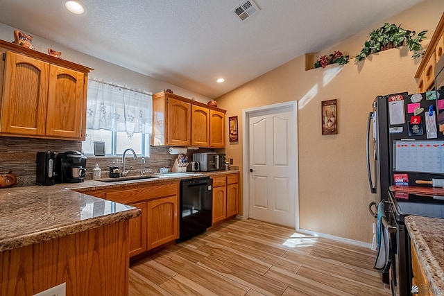 kitchen featuring dishwasher, electric range, a sink, and brown cabinets