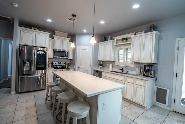 kitchen featuring hanging light fixtures, stainless steel appliances, light tile patterned floors, a breakfast bar, and a kitchen island