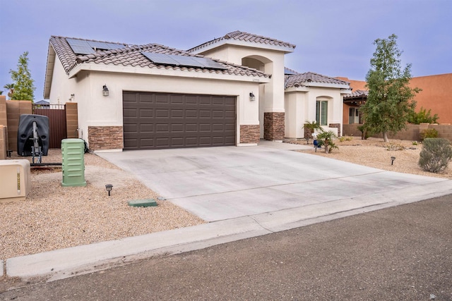 view of front of property with solar panels and a garage